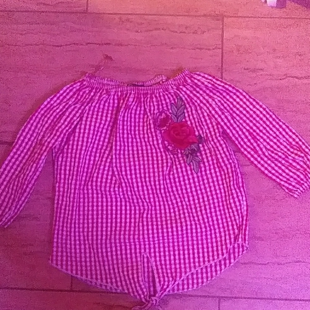 I am selling a red lined shirt with a big flower